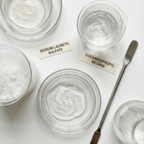 Bechers de laboratoire contenant un gel douche industriel formulé avec tensioactifs et agents moussants